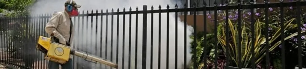 Mosquito control technician fogging a yard perimeter for mosquito reduction in Phoenix, AZ